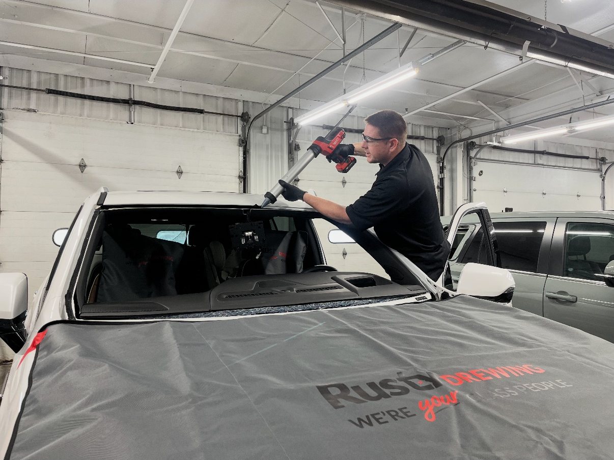 Rusty Drewing glass technician setting a new windshield on a pickup in the Jefferson City shop